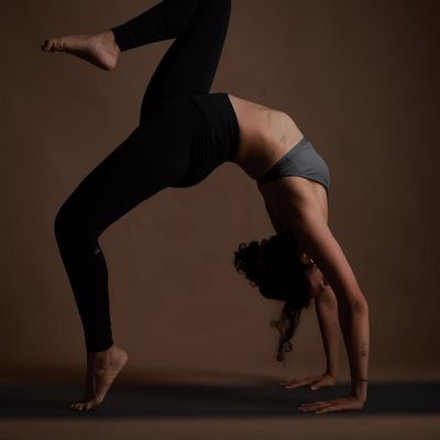 An upward stretching pose against a dark background.
